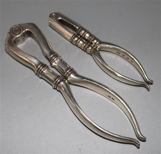 A pair of George V silver nut crackers by Collins & Co, (Dryad Art Metal Works), 6 oz.